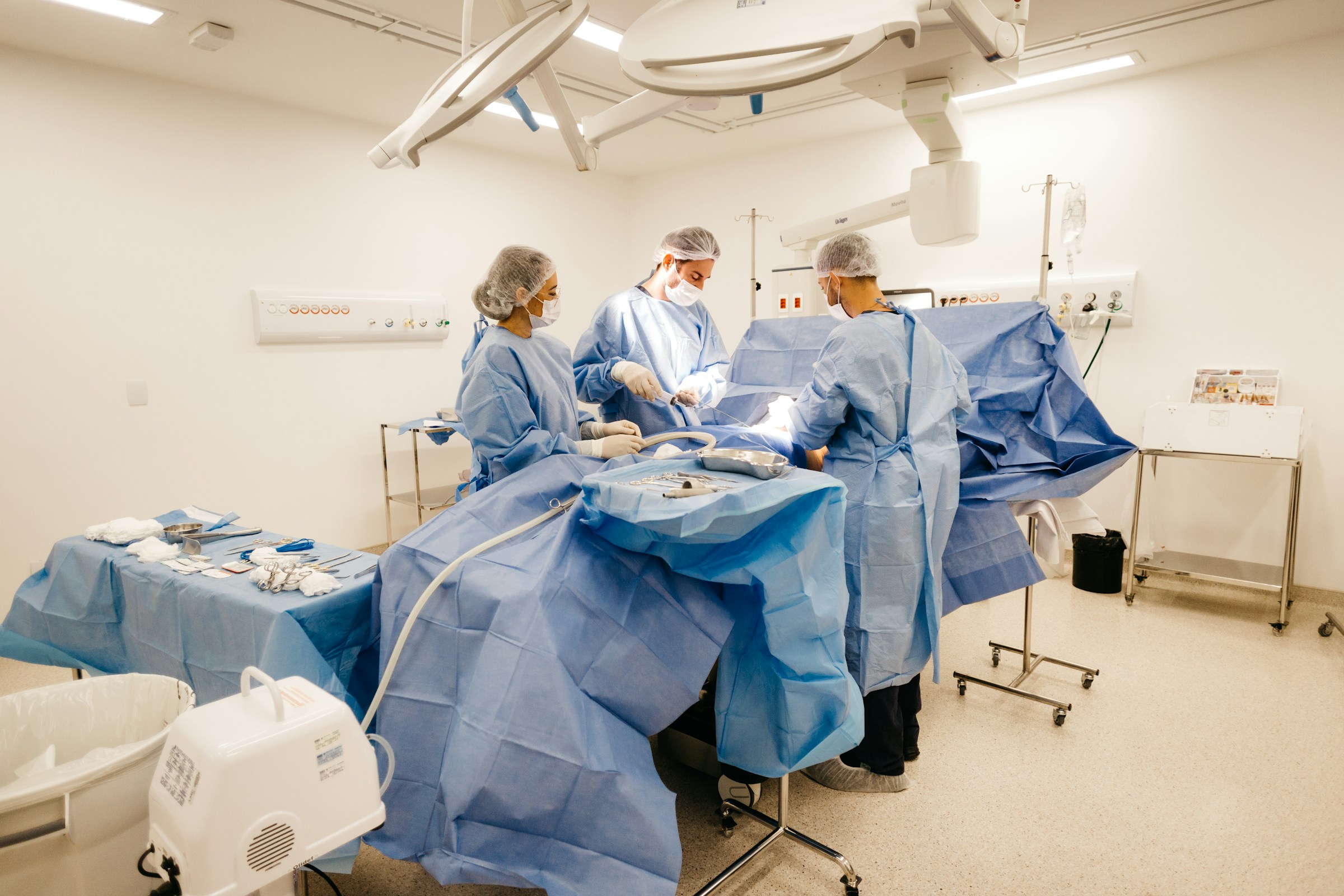 Clinical team performing a minor procedure in a sterile room
